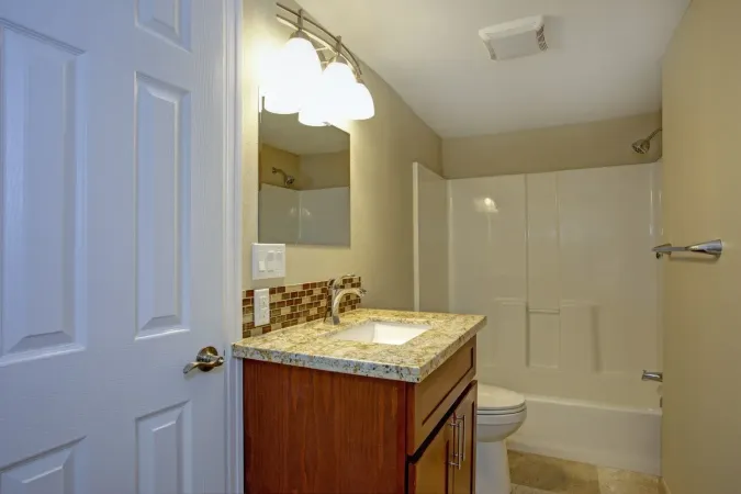 Stunning bathroom with mosaic tile backsplash.